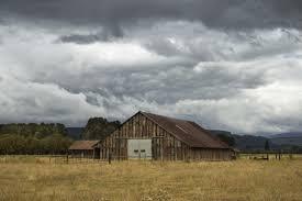 Wooden barn with an overcast sky in the background