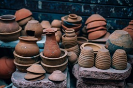 Large assortment of different pottery pieces piled up